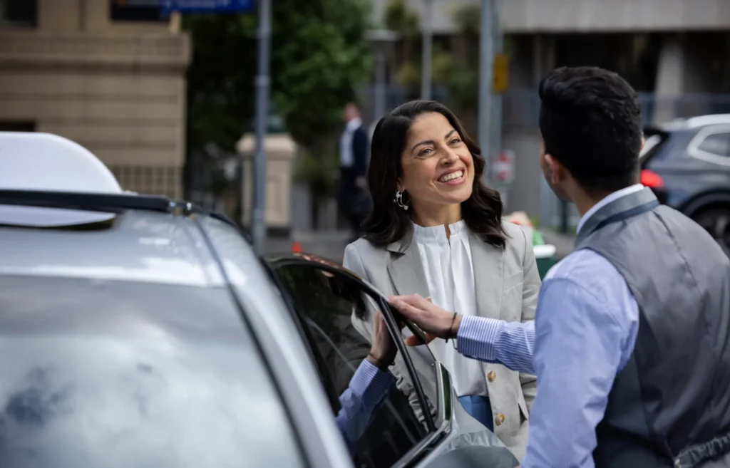 Silver Service driver assisting passenger into vehicle